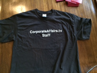 front of groovy CorporateAffairs.tv Staff t-shirt 